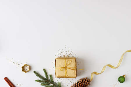A gift with decorations on white background. Christmas or holiday concept. Flat lay, copy spaceの写真素材