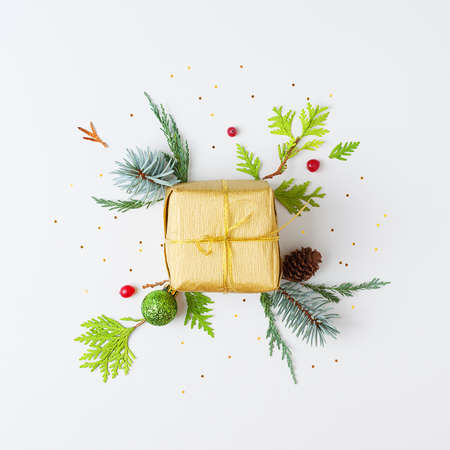A gift with decorations on white background. Christmas or holiday conceptの写真素材