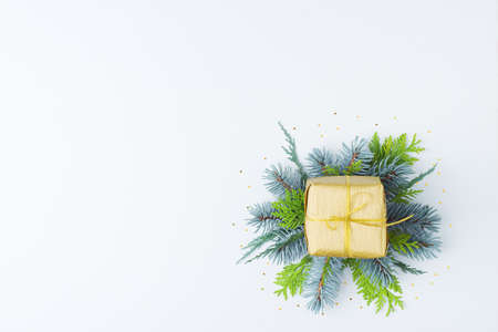A gift with decorations on white background. Christmas or holiday concept. Flat lay, copy spaceの写真素材