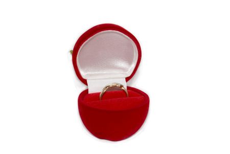 Red casket with a gold ring isolated on white
