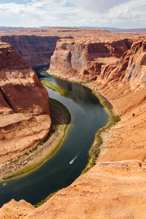 Horseshoe Bend with a boat in the river, Page, Arizona, USAの写真素材