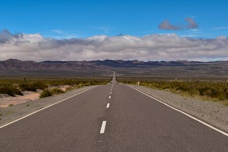A long road in the middle of a landscapeの写真素材