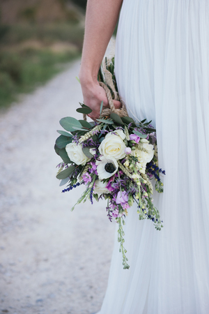 details of rustic wedding bouquet with lavender and white flowersの写真素材