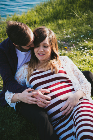 young couple attended child outdoor, by the riverの写真素材