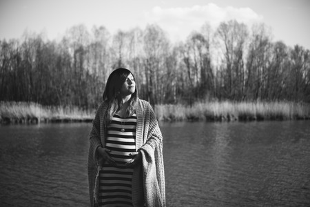 portrait of a pregnant woman by the riverの写真素材