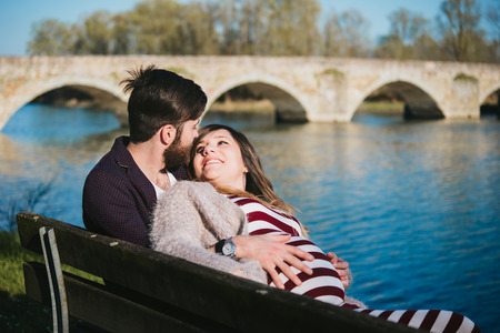 young couple attended child outdoor, by the riverの写真素材