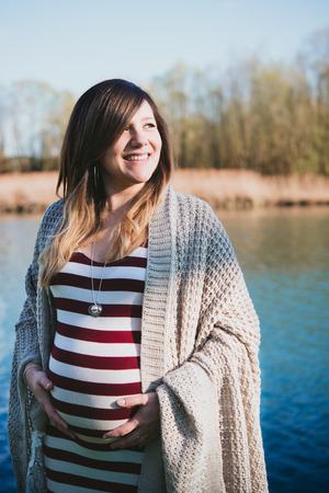 portrait of a pregnant woman by the riverの写真素材