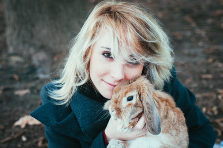 portrait of a woman with rubbitの写真素材