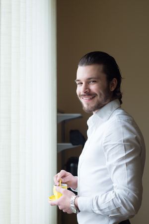 businessman has a coffee break in officeの写真素材