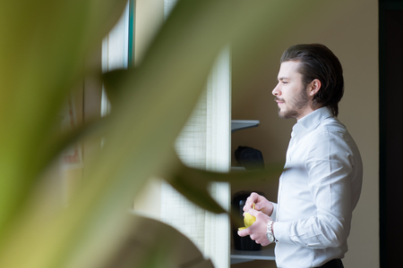 businessman has a coffee break in officeの写真素材