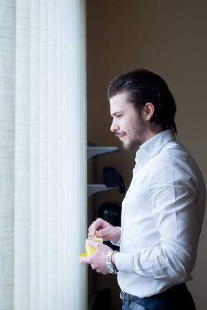 businessman has a coffee break in officeの写真素材