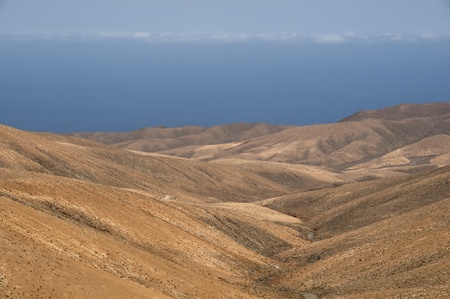 Fuerteventura desert   The sea and sky appear to merge at the horizon in the background の写真素材