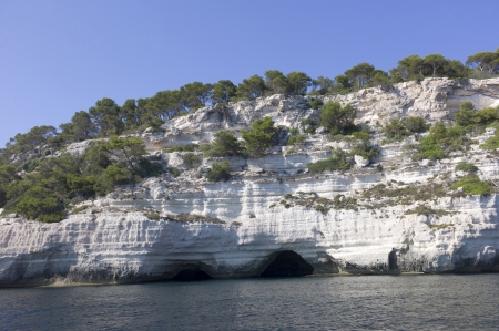 Natural caves in the limestone rock of the south coast of Menorcaの写真素材