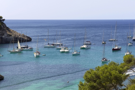 Sailboats anchored in Cala Galdana, Menorcaの写真素材
