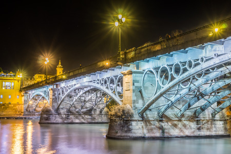 Seville is divided in two by the river Guadalquivir, and its most famous bridge is the Triana bridge, connecting the historic center to the Triana region.の写真素材