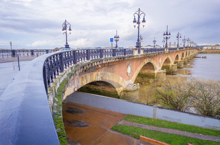 The Stone bridge (Pont de pierre) is located in Bordeaux, France. It connects the left bank of the Garonne River to the right bank quartier de la Bastide.の写真素材