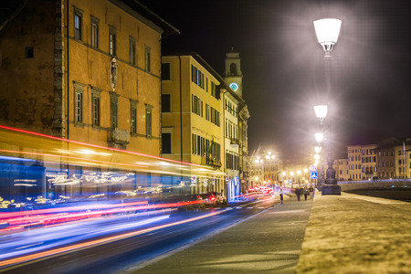 The city of Pisa, Tuscany, Italy, is crossed by the Arno river, and its margin are used as busy roads going in and out of the city center.の写真素材