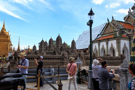Tourists view a replica of the Angkor Wat Palace in the Royal Palace of Bangkokのeditorial素材