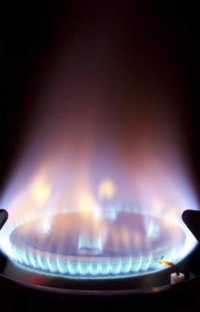 bright blue flame burning on a gas hob 
