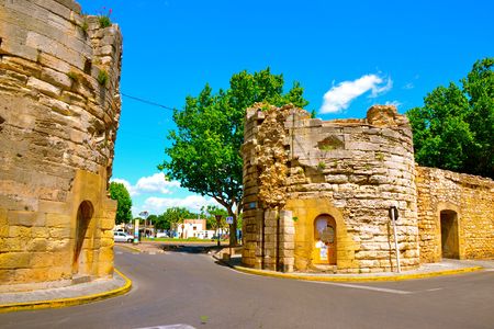 Driving down a road that passes through the historic walls of Arles, Franceの写真素材