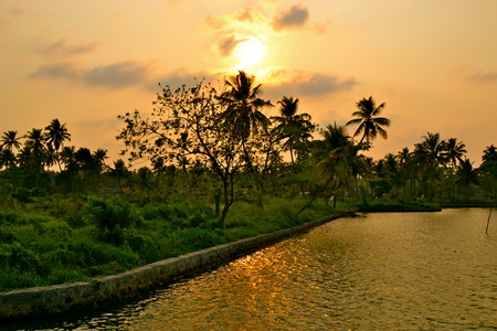Sunset over a canal in Kerala, Indiaの写真素材