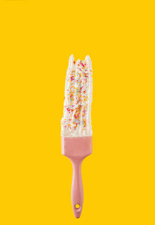 Bold pop art background idea concept. Paint brush trend color leave whipped cream with unicorn sprinkles. Minimalist background.の写真素材