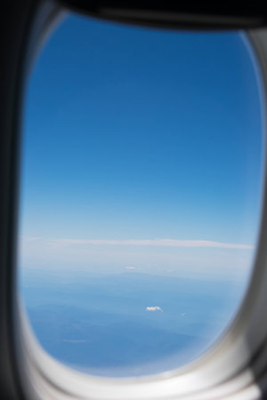 Looking out of the plane window at landscape.