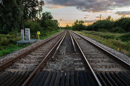 Canterbury, Kent, England - September 11 2020: Railway tracks on the Canterbury to London route stretch out into the distance under an evening sunset sky on September 11, 2020 in Canterbury.のeditorial素材