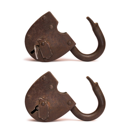 Old rusty opened padlock isolated on white background, key in the lockの写真素材