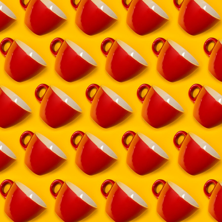 Pattern of red cups on a yellow background