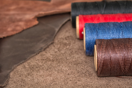 Natural leather and bobbins of wax yarns.の写真素材