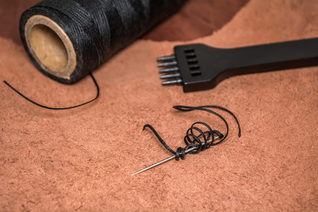 Natural leather, tool for creating products and bobbins of wax yarns.の写真素材