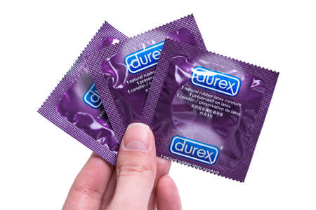 Kyiv, Ukraine - 22 May 2020: Three Durex Elite condoms in hand. Healthy and safe sex.のeditorial素材