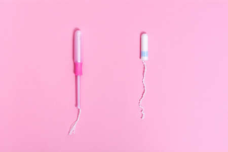 Tampon with applicator and tampon without applicator. Product for female intimate hygiene. Concept about the choice.の写真素材