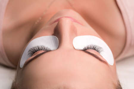 Woman with long lashes in a beauty salon. Eyelash extension.