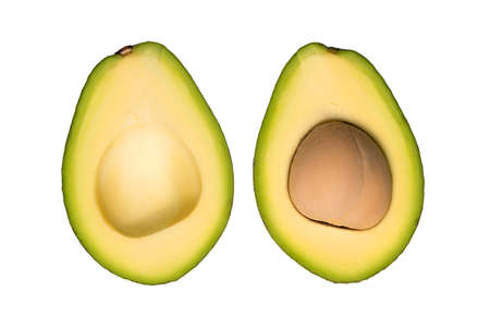 Two halves of ripe avocado isolated on a white background