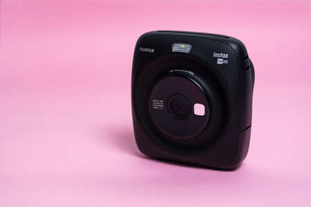 Kyiv, Ukraine - 14 July 2020: Fujifilm Instax Sq 20 Black on apink background.