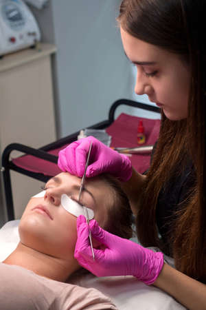 Woman with long lashes in a beauty salon. Eyelash extension.