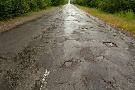 Very bad road surface. Holes on the road.の写真素材