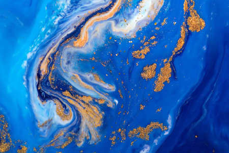 Luxury fluid art painting background. Spilled blue, white and gold acrylic paint. liquid marble. Alcohol ink splash.の写真素材