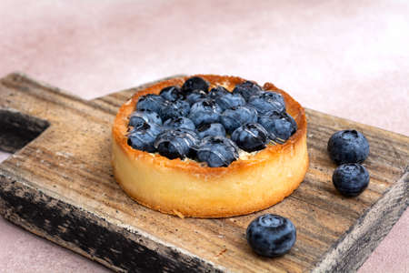 Blueberry pie on a wooden board. blueberry tart. Berry dessert on a wooden background.の写真素材