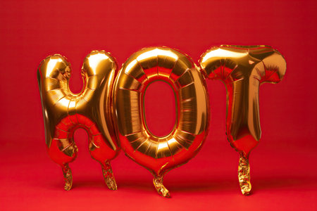 The word HOT made from balloons on a red backgroundの素材