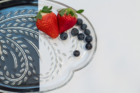 Strawberries and blueberries with black and white backgroundの写真素材