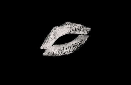 Kissing white lips on a black backgroundの写真素材