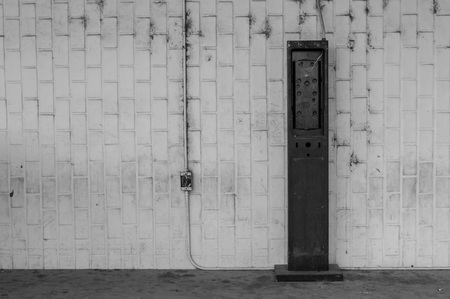Black and white photo   Remnants of a payphone.の写真素材
