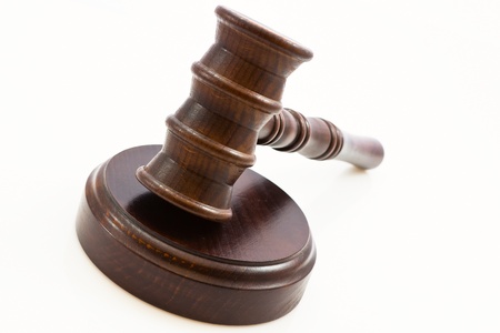 wooden judge gavel and wooden stand on a white background