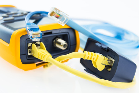 network RJ45 cable tester and a few various cables prepered to testing