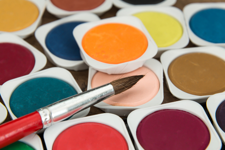 new unused of children's multicolor watercolor paints with paint brushの写真素材