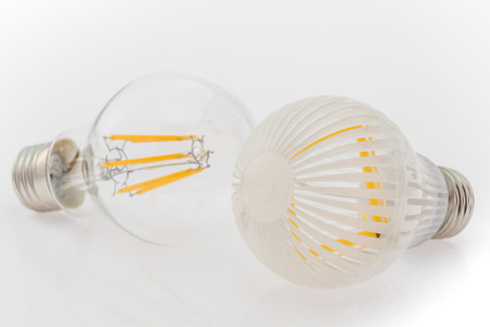two LED bulbs with different cover, plastic and glass, focusing on the bulb in the foreground