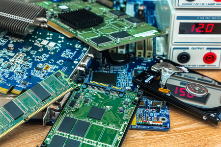 The heap of electronic boards with SSD and HDD from the computer on the service desk at the power...